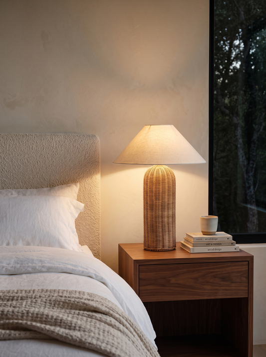 Rina rattan table lamp on a walnut nightstand in a japandi bedroom