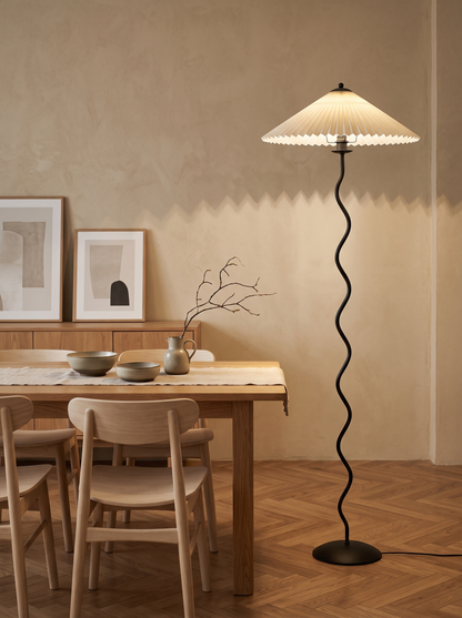 Dune floor lamp beside an oak dining table