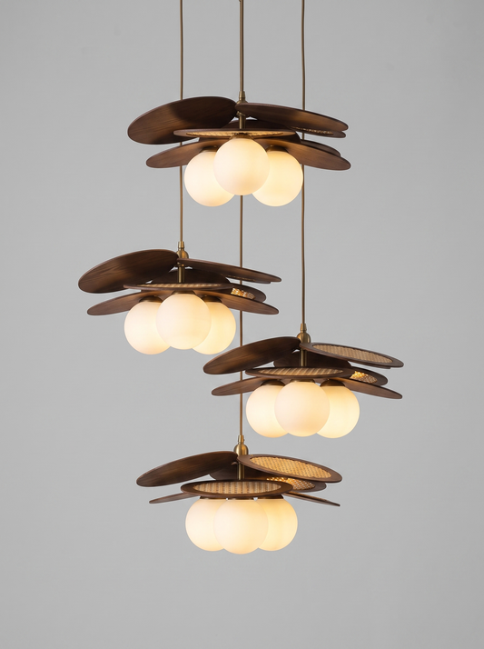 Ashi woven rattan three-light pendant, studio view, lit