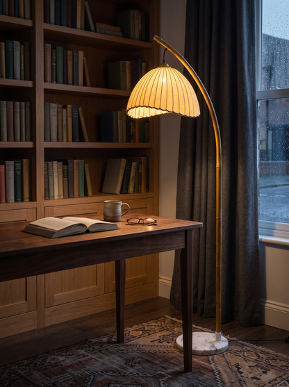 Suna floor lamp beside a walnut writing desk
