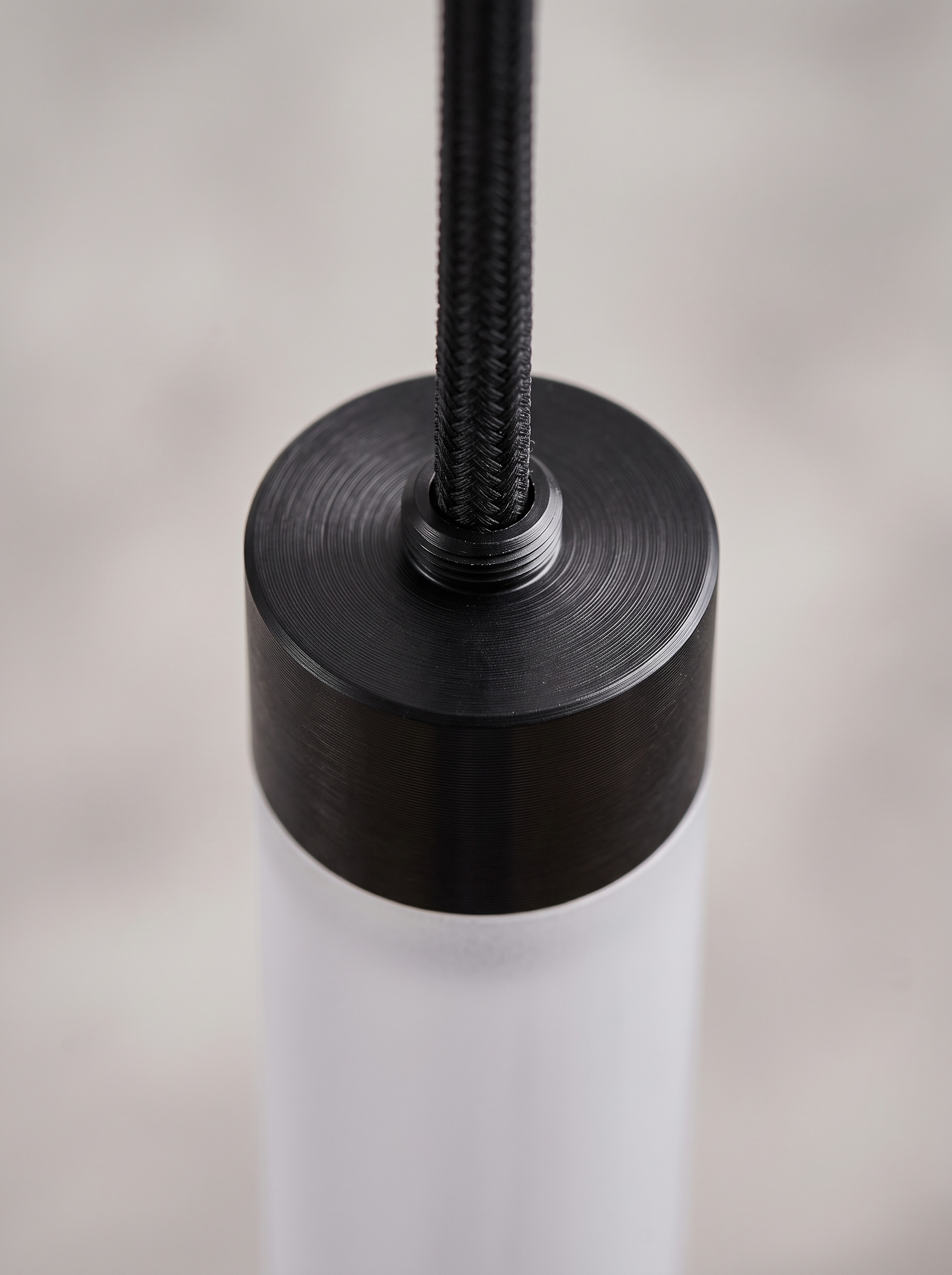 Macro detail of the anodised aluminium top cap and cord