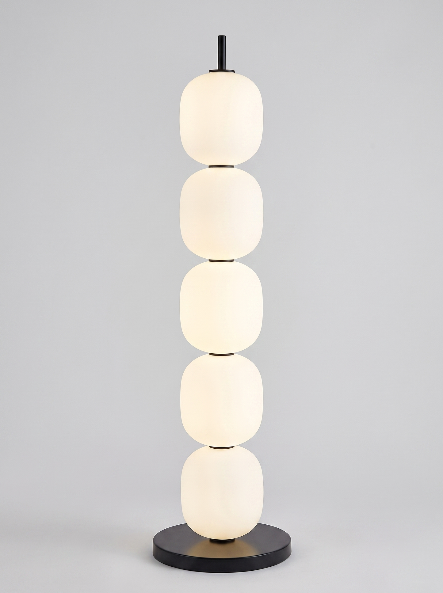Sasso stacked opal glass floor lamp on light grey studio background