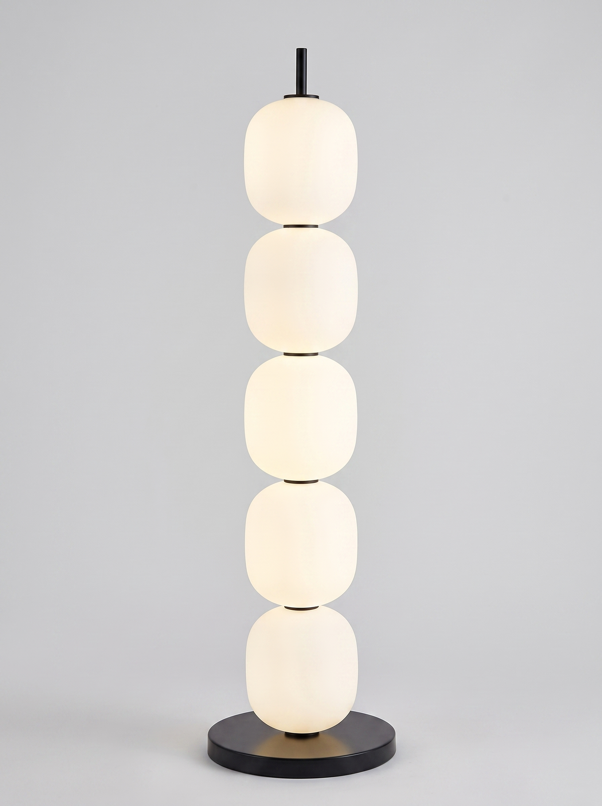Sasso stacked opal glass floor lamp on light grey studio background