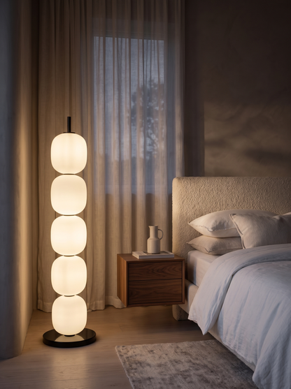 Sasso floor lamp beside a bed in a serene bedroom