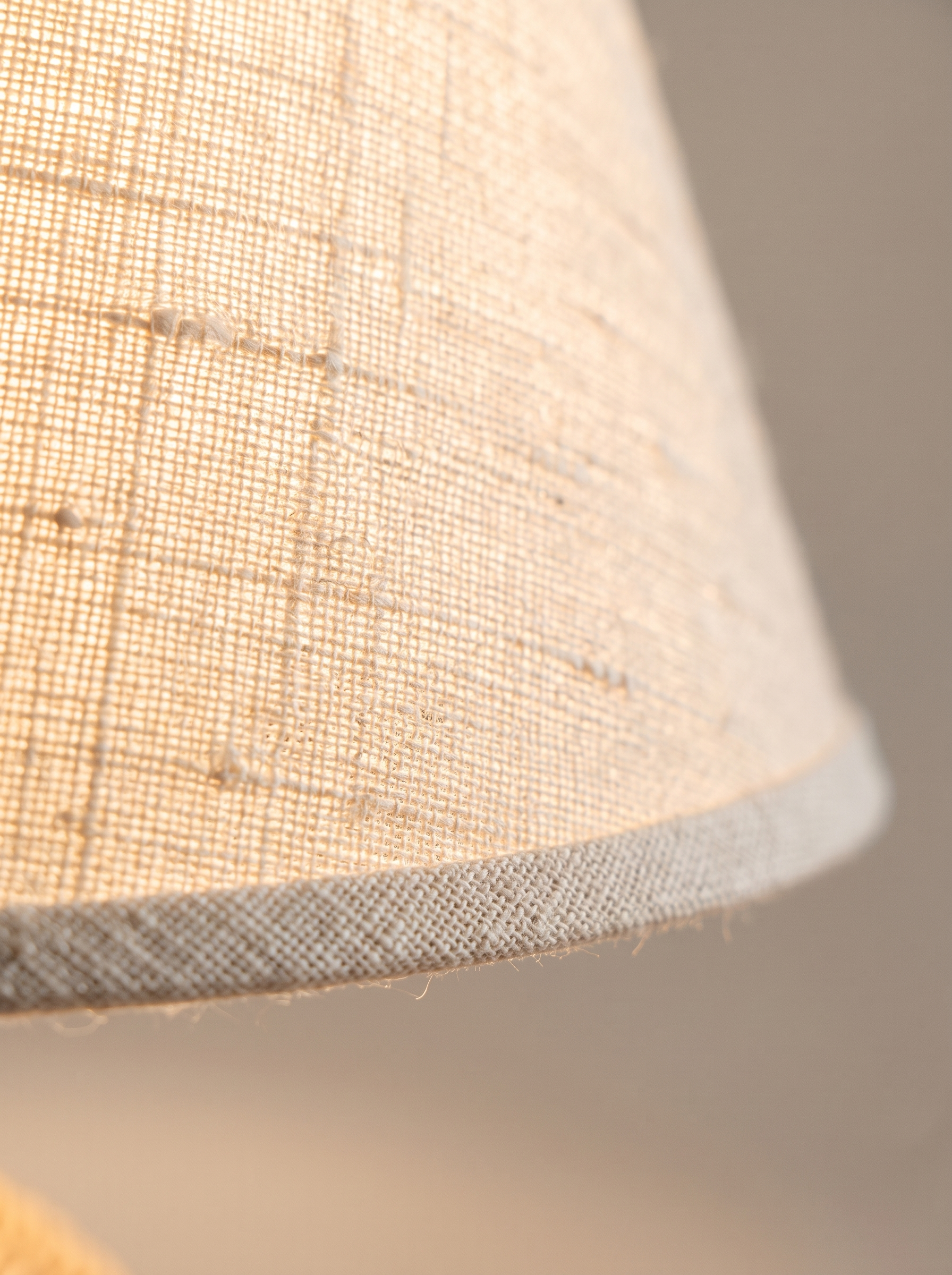 Macro detail of the backlit natural linen shade